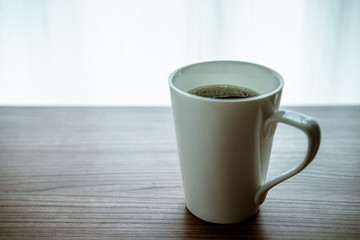 A cup of coffee on the wooden table