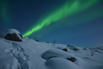 Fotobehang The northern lights (Aurora Borealis) over Seljelvnes, Troms by the sea and the snowy mountains © BAHADIRARAL