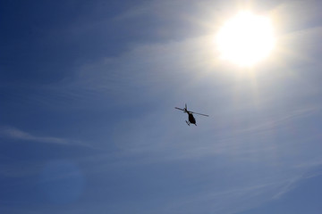 Helicopter in the sky and bright sun