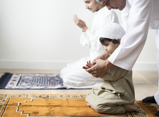 Fototapeta premium Muslim boy learning how to make Dua to Allah