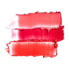 Smudged lipsticks isolated on white background