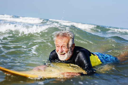 Mature surfer ready to catch a wave