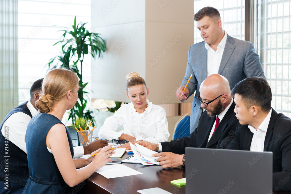 Wall mural business people working together at conference table