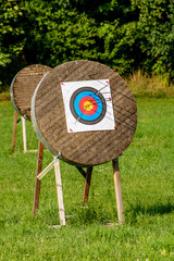 View of archery target with arrows sticking in various circles