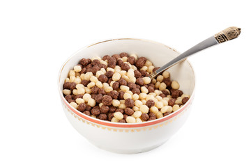 Cereal balls for breakfast in a bowl isolated on white background