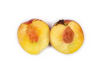 Naklejka na ściany i meble Fresh ripe peach fruit sliced in half isolated on white background, top view