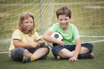 Fototapeta na wymiar child soccer (football) player. Boy with ball on green grass.