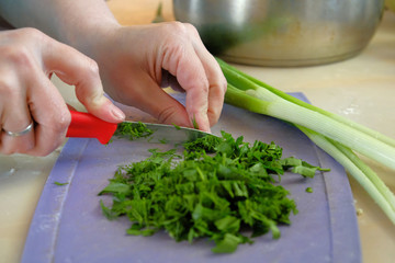 the chef cuts green salad