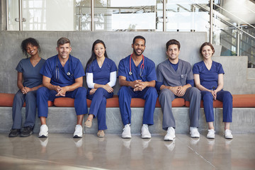 Healthcare workers sitting in a modern hospital, low angle - obrazy, fototapety, plakaty