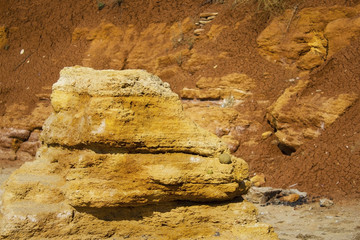 the surface texture of the slope from dry sand-clay granular soils with a reddish tinge