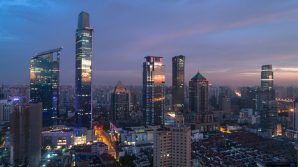 Fototapeta na wymiar colorful reflection of dawn light on glass of buildings windows, Jingan district, Shanghai, China.