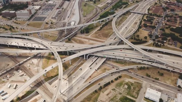 Drone shot flying over cars driving on mix master highway interchange