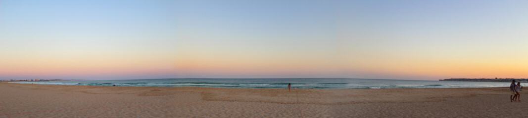 Sunset on sandy beach near Sagres village in Portug