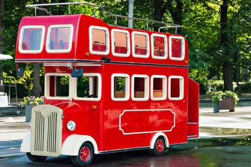 the red double-decker bus in city park