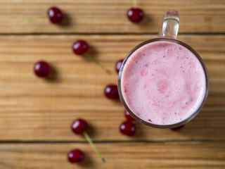 Cherry smoothie on wooden rustic table top view