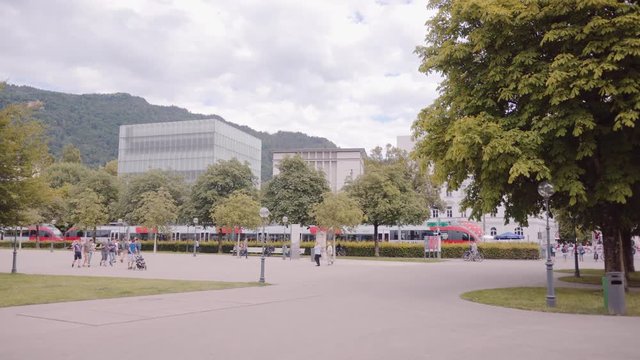 The local train passing by an urban scenery in Vorarlberg, Austria