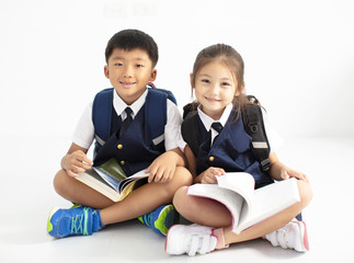 happy little boy and girl student studying