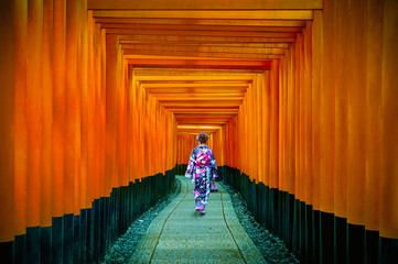 Fototapeta premium Asian women in traditional japanese kimonos at Fushimi Inari Shrine in Kyoto, Japan.