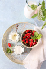 Healthy milk dessert: two jars of fresh yogurt and wild strawberry