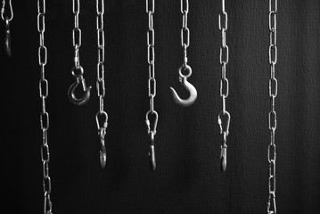 Fototapeta na wymiar steel chains with hooks in monochrome