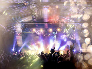 Live music crowd under a firework show
