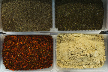 Spices and condiments in boxes on the counter of the vegetable market. 