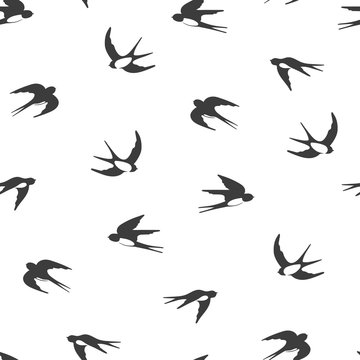 Flying swallows silhouettes. Black and white seamless pattern.