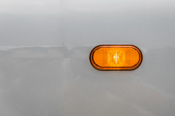 yellow light turn signal on a silver car