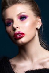 Fototapeta premium Portrait of blond model with professional makeup, perfect skin, creative lips art. Trendy colorful smoky eyes. Red and lilac smoky eyes