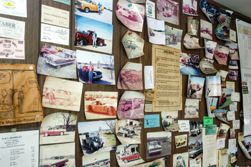 Board with memorabilia and postcards of vintage cars
