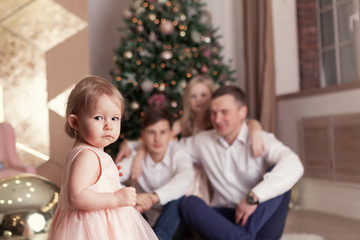 Portrait of beautiful happy family, merry father, daughter and son are sin Christmas decorations,