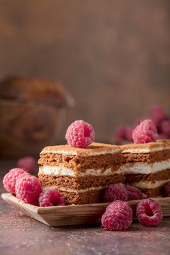Layered honey cake with cream and raspberries.