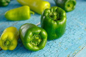 Green peppers on the blue wooden background
