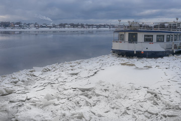 Vintage steamboat among the ice on the river