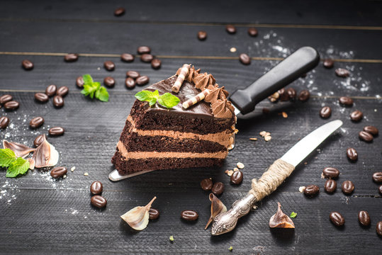 Delicious Piece Of Chocolate Cake With Layers On The Black Background