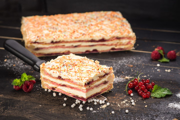 Sweet cake with layers on black background