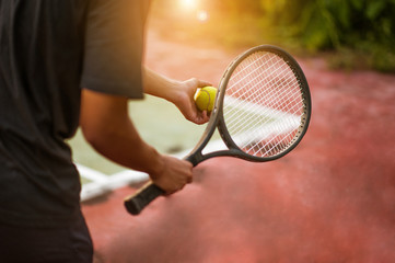 A tennis player prepares to serve a tennis ball during a match
