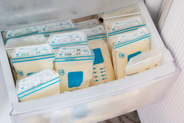 breast milk in plastic bags on refrigerator shelf, frozen mother milk  for infant, breastfeeding