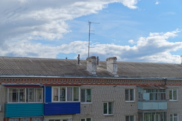 Roof of an old apartment house against amazing cloudy sky. Komsomolsk-on-Amure, Russia