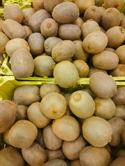 Kiwi fruits on the counter for sale in a vegetable shop.