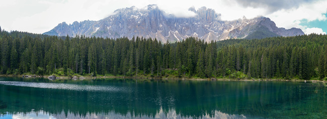 Lake Carezza with reflection of mountains in the Dolomites