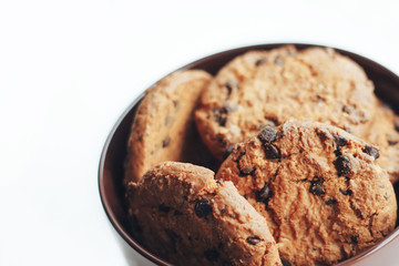Chocolate cookies in a brown bowl on a white background