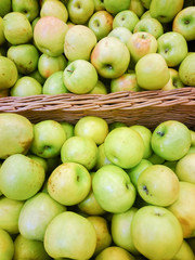 Green apples on the counter in the supermarket.