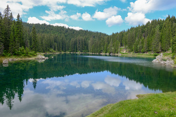 Obraz premium Lake Carezza with reflection of mountains in the Dolomites