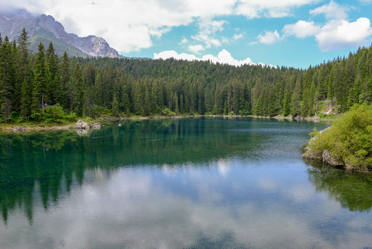 Lake Carezza with reflection of mountains in the Dolomites