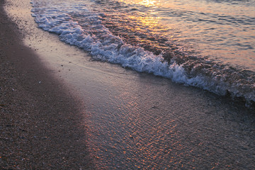 The glare of Sunrise the Sun on the sea sand 