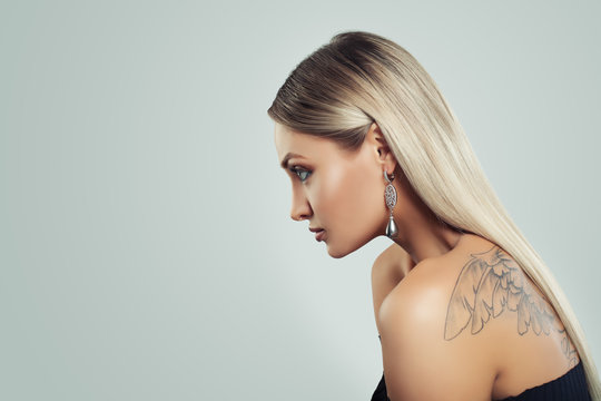 Woman with Healthy Blonde Hairstyle, Makeup and Black Pearls Earrings on Background with Copy space
