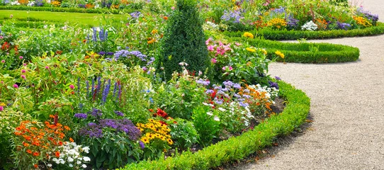 Washable wall murals Flowers Lush flower beds in the summer garden.Wide photo.