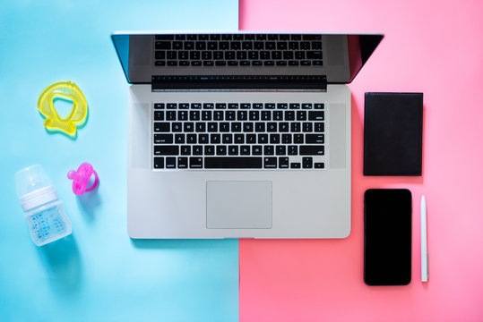 Working Mom Top View Flatlay Of Workplace Baby Items And Laptop With Phone