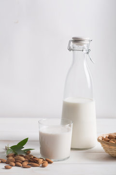 Almond milk on a white wooden table
